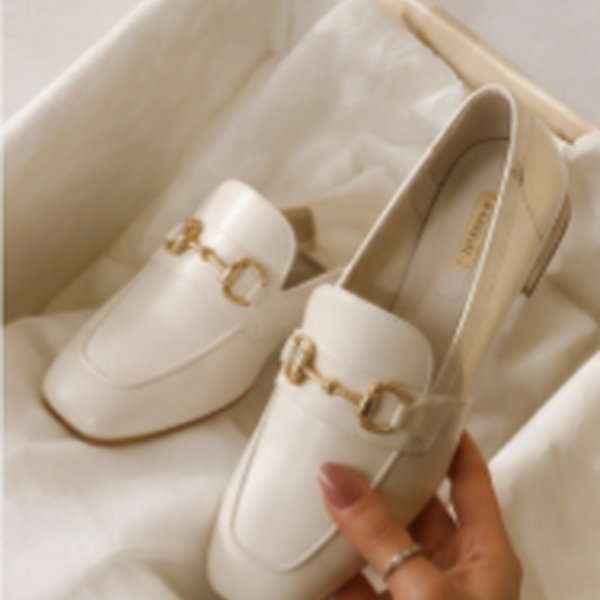 White loafers with gold buckle